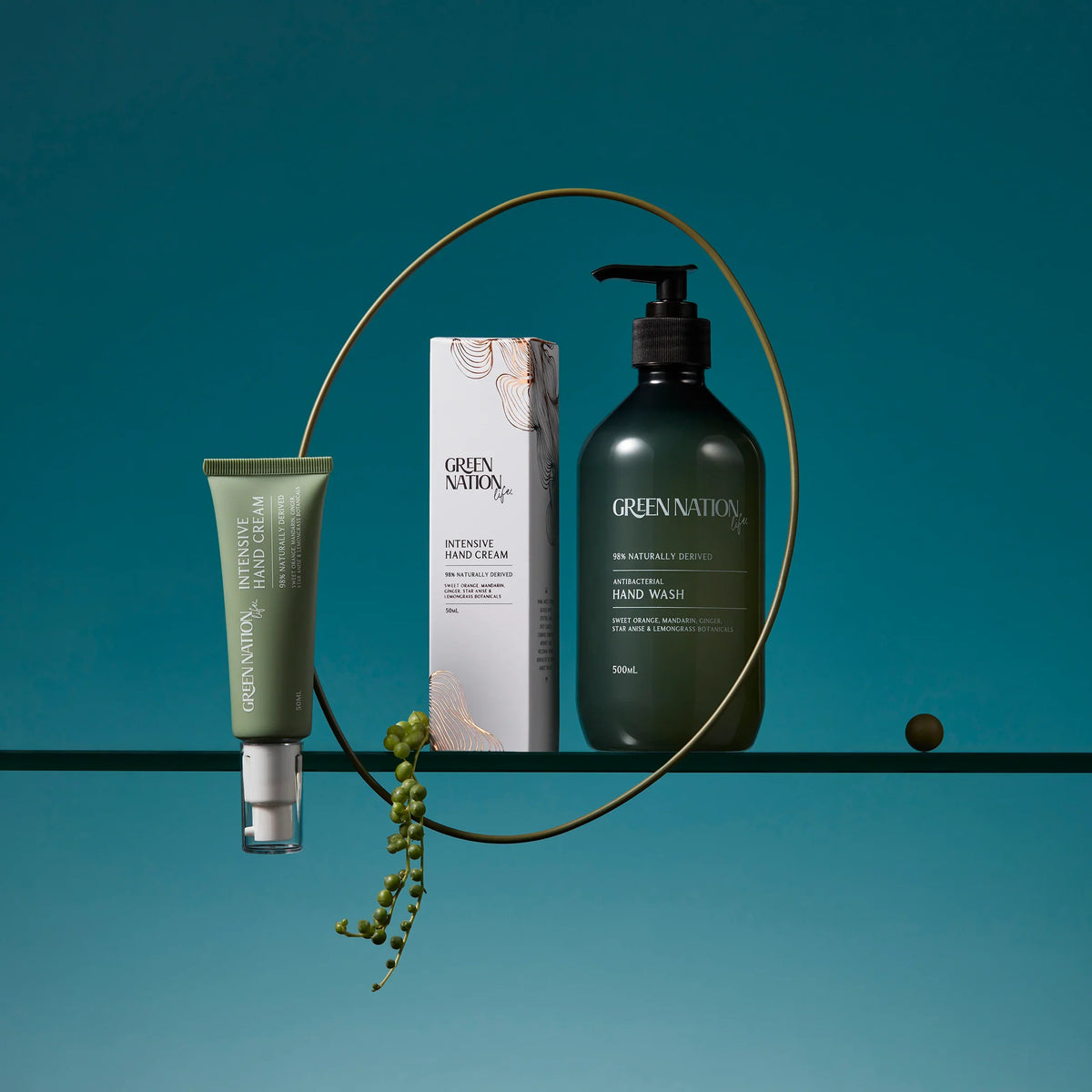 Green Nation hand wash and intensive hand cream set on teal background with product packaging